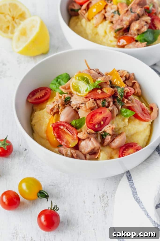 This vegan grits recipe is the perfect gluten-free meal! Creamy vegan polenta cooked in coconut milk is topped with savory jackfruit confit with tomatoes and basil!