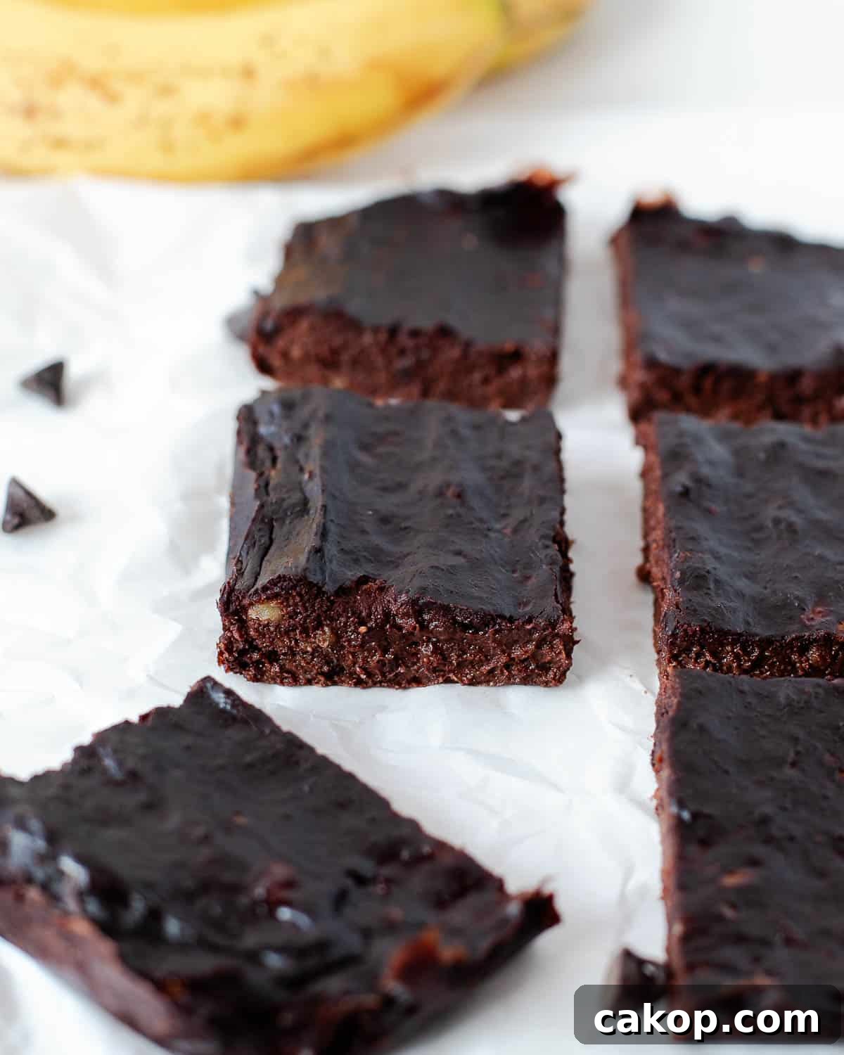 Close-up of fudgy 3 ingredient banana brownie squares showing dense, moist texture.