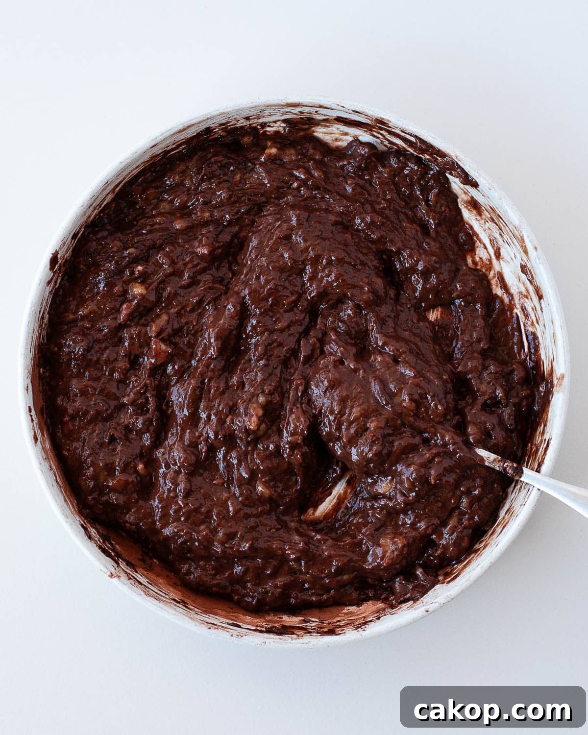 Thick chocolate banana brownie batter mixed in a bowl before baking flourless 3 ingredient banana brownies.