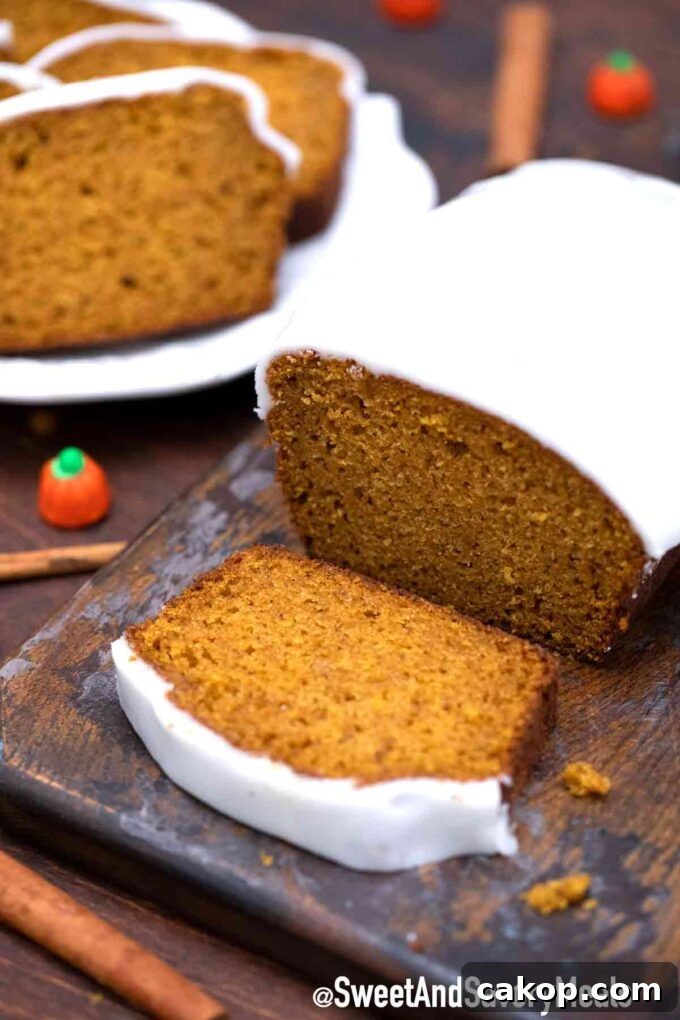 Ultimate Pumpkin Bread Recipe for Moist, Spiced Loaf 5 Sliced pumpkin bread with frosting on a wooden board