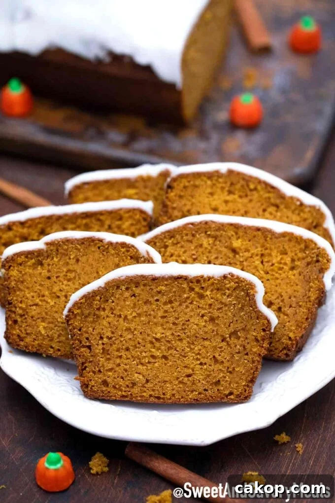 Ultimate Pumpkin Bread Recipe for Moist, Spiced Loaf 6 Sliced pumpkin bread on a white plate