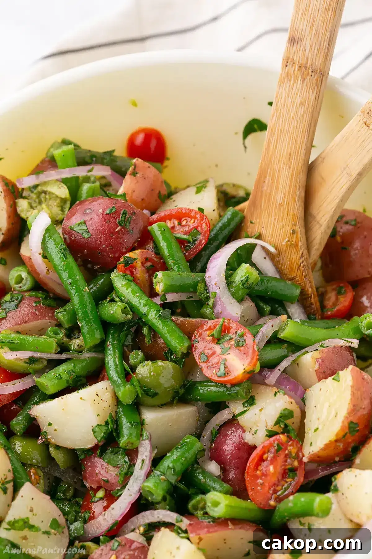 Top Side Dishes to Serve with Fried Fish 3 A close up on a bowl with potato salad with a wooden spoons.