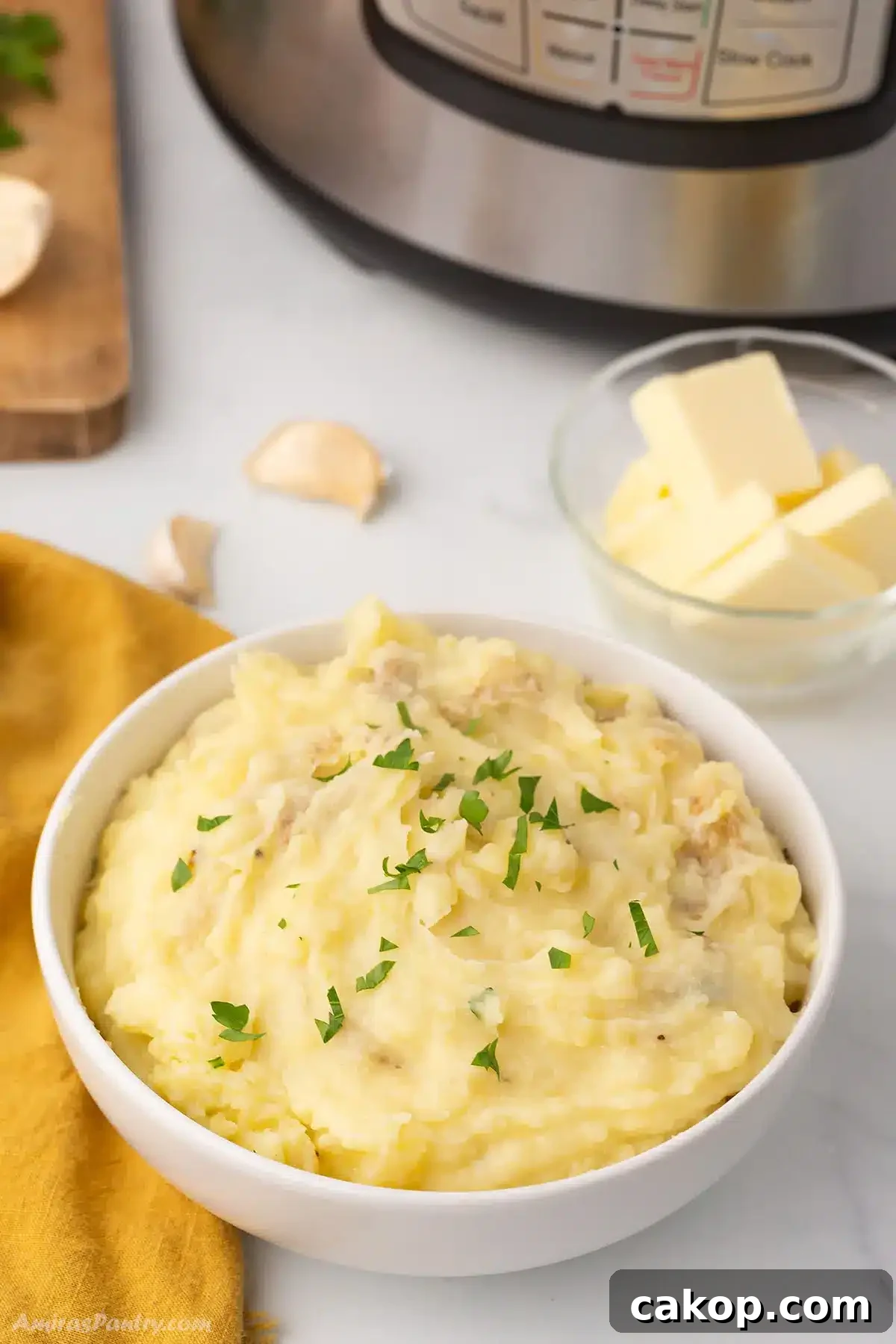 Top Side Dishes to Serve with Fried Fish 4 A big bowl of mashed potatoes with an instant pot in the back.