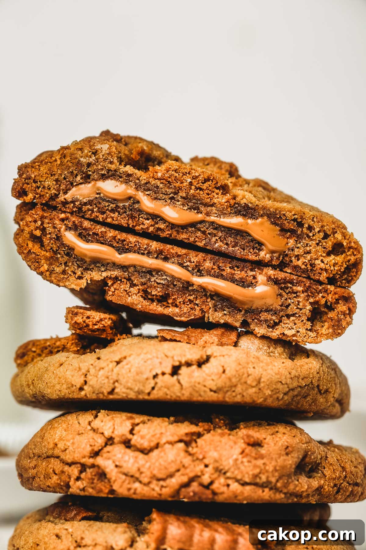Biscoff Cookie Butter Cookies Recipe — Crunchy Spiced Biscuits 10 Biscoff stuffed cookie cut in half showing gooey center