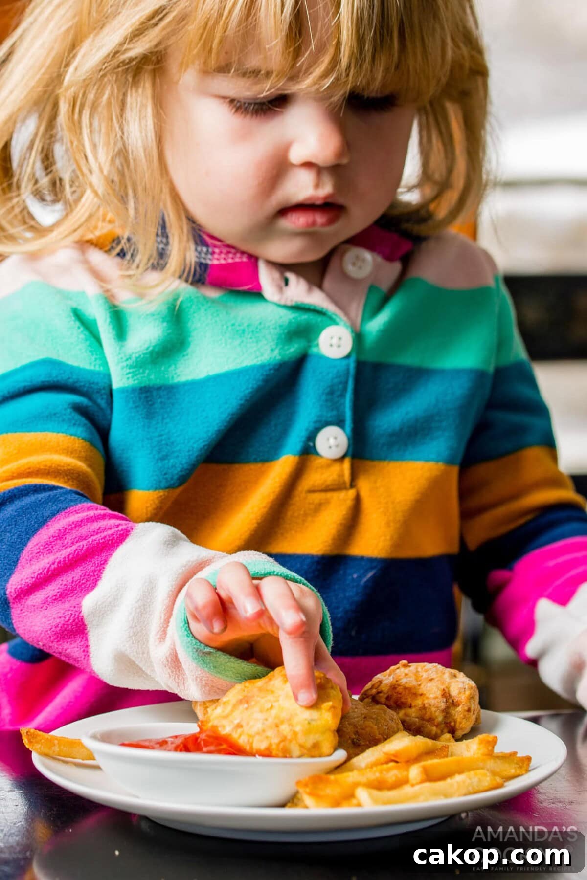 Crispy Air Fryer Chicken Nuggets Recipe for Perfect Crunch 10 little girl dipping an air fryer chicken nugget