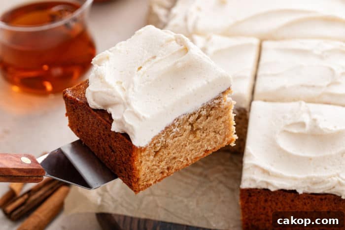 Cake server lifting up a slice of apple butter cake.