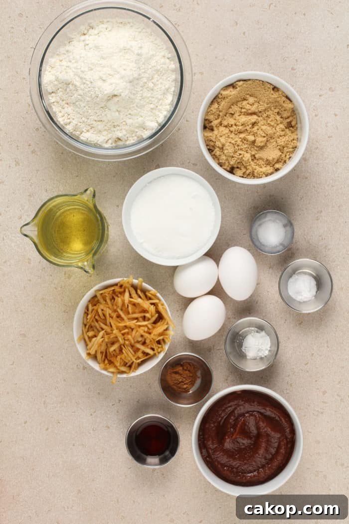 Ingredients for apple butter cake arranged on a beige countertop.