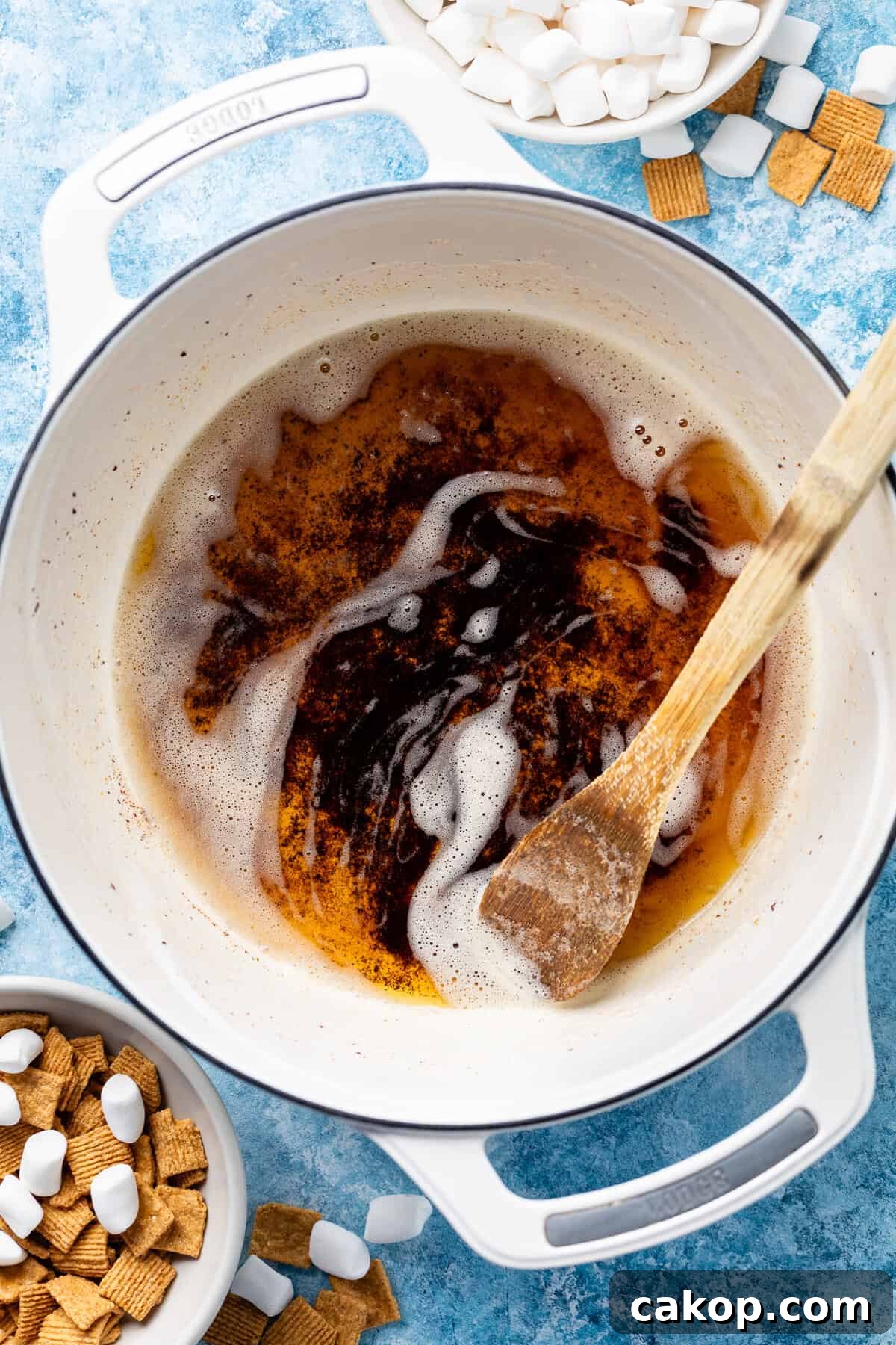 making golden graham rice krispies bowl with wooden spoon