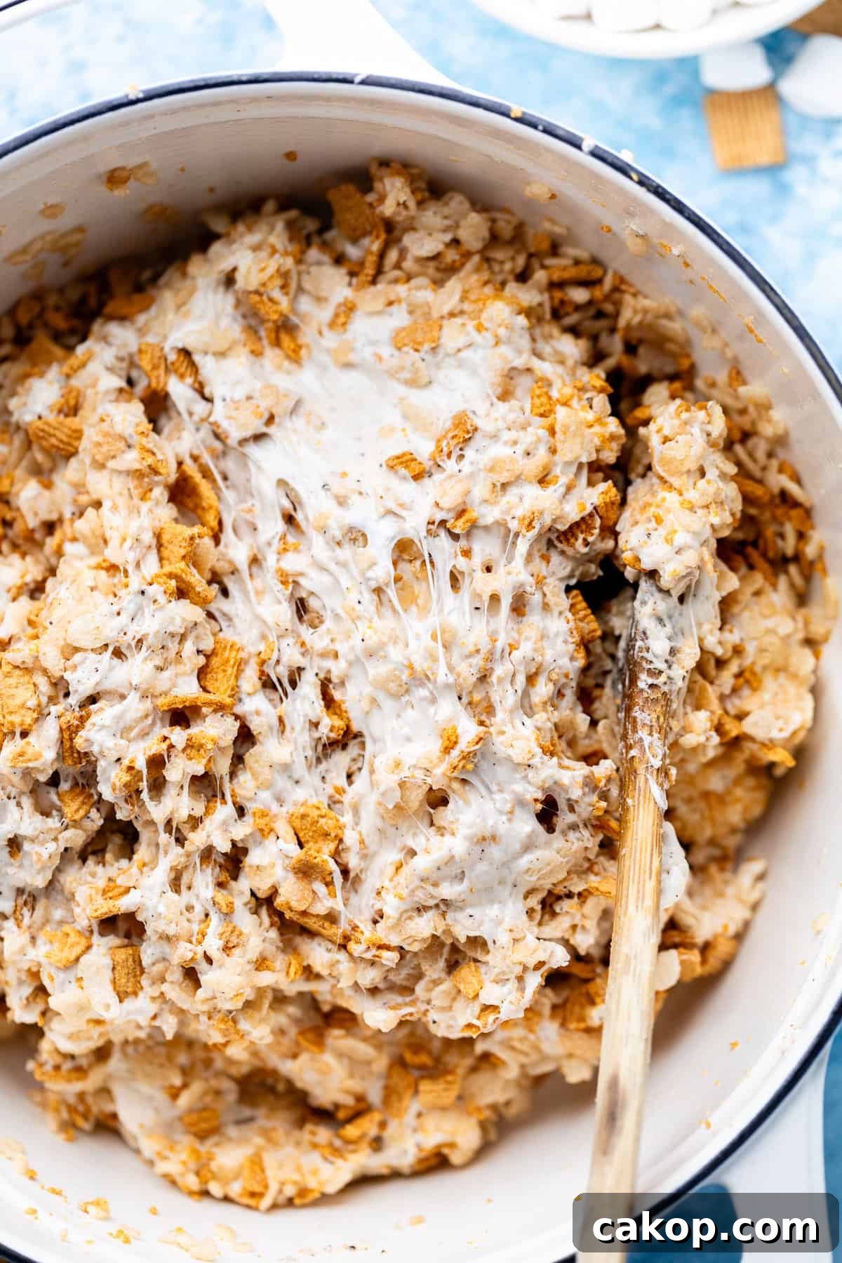 making golden graham rice krispies bowl with wooden spoon