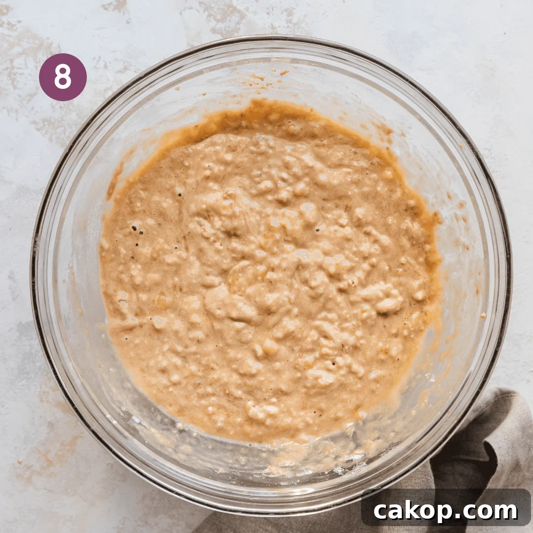 thick vegan banana bread batter in a glass bowl.