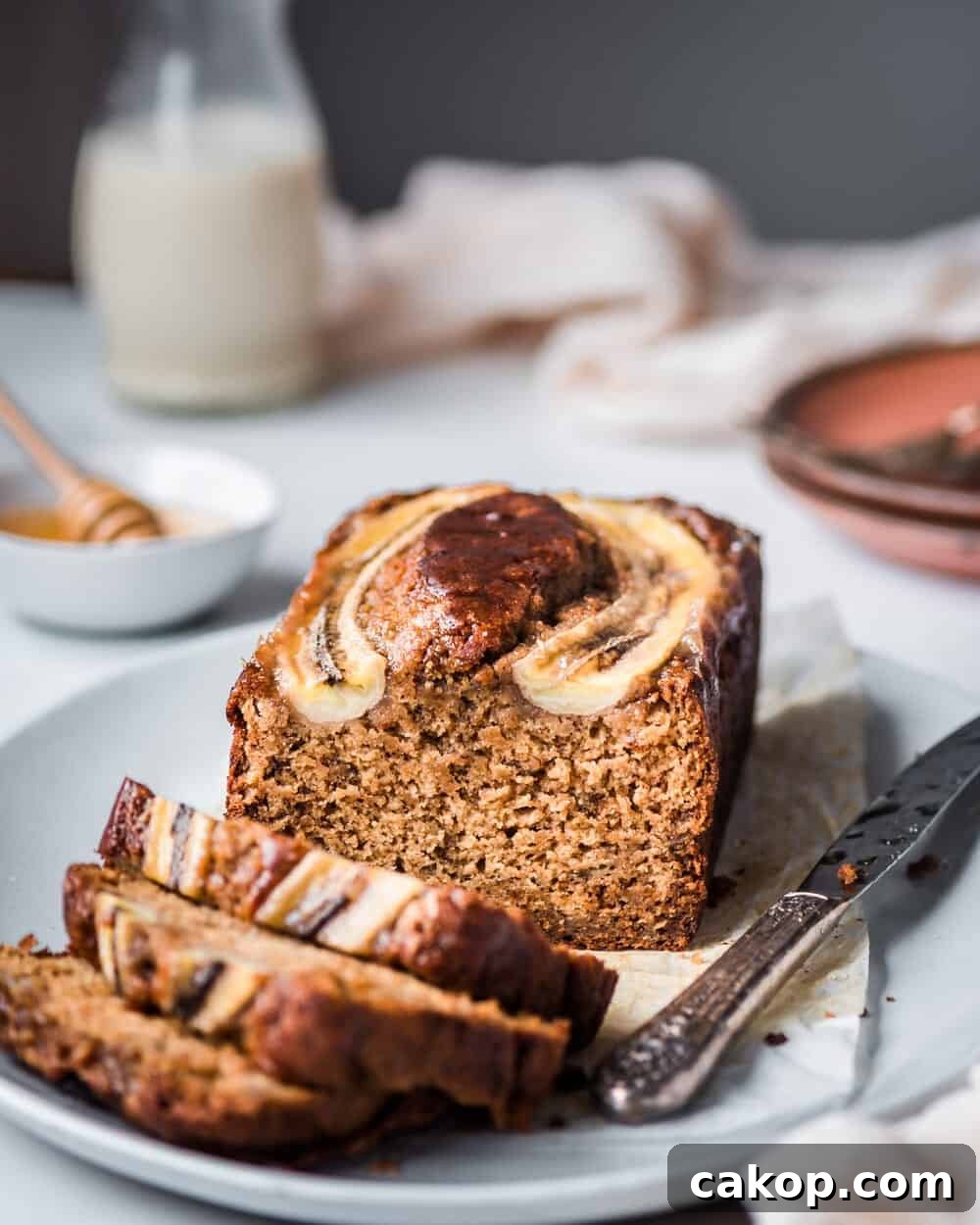 loaf of banana bread on tray with three slices 