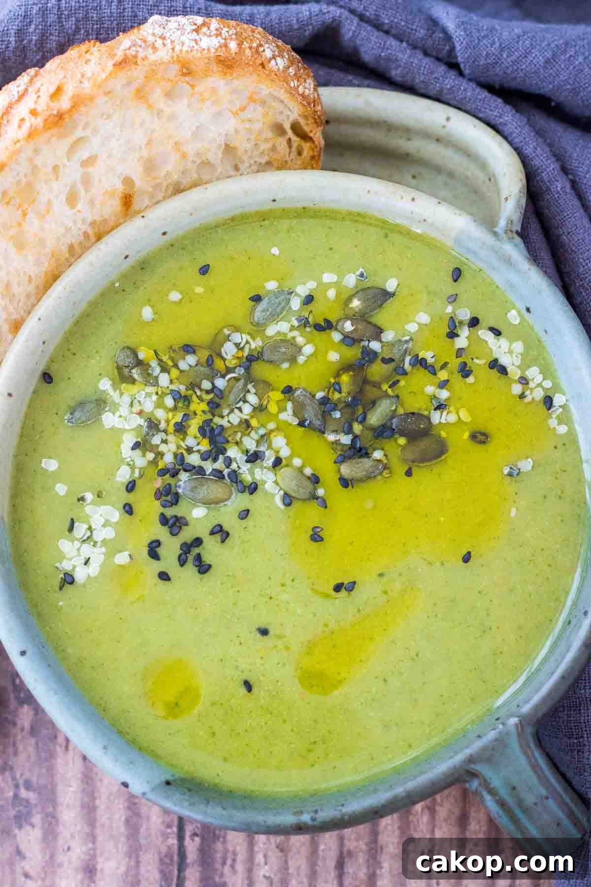 Fiery Roasted Broccoli Soup with Garlic and Chili Oil 2 Creamy Spicy Broccoli Soup served in a bowl topped with pumpkin seeds