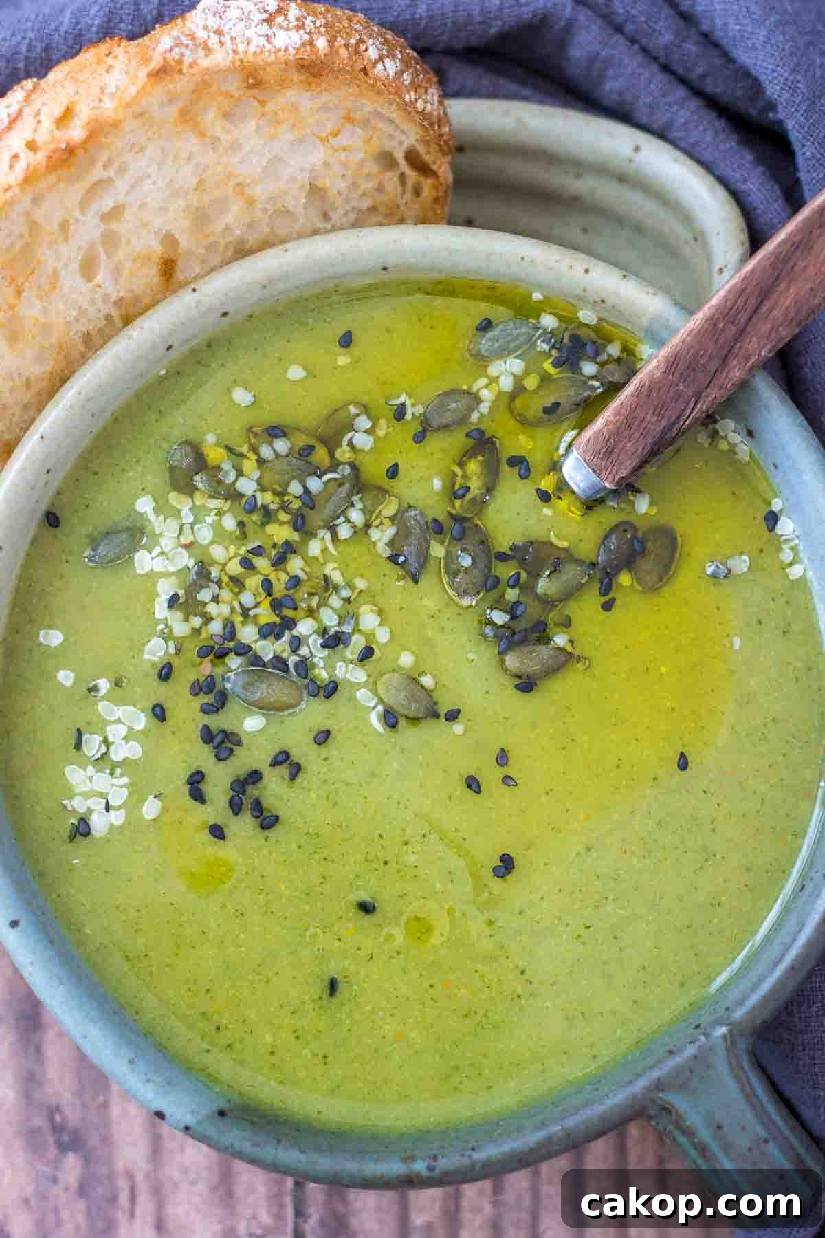 Fiery Roasted Broccoli Soup with Garlic and Chili Oil 7 Creamy Broccoli Soup served in a bowl with a slice of bread