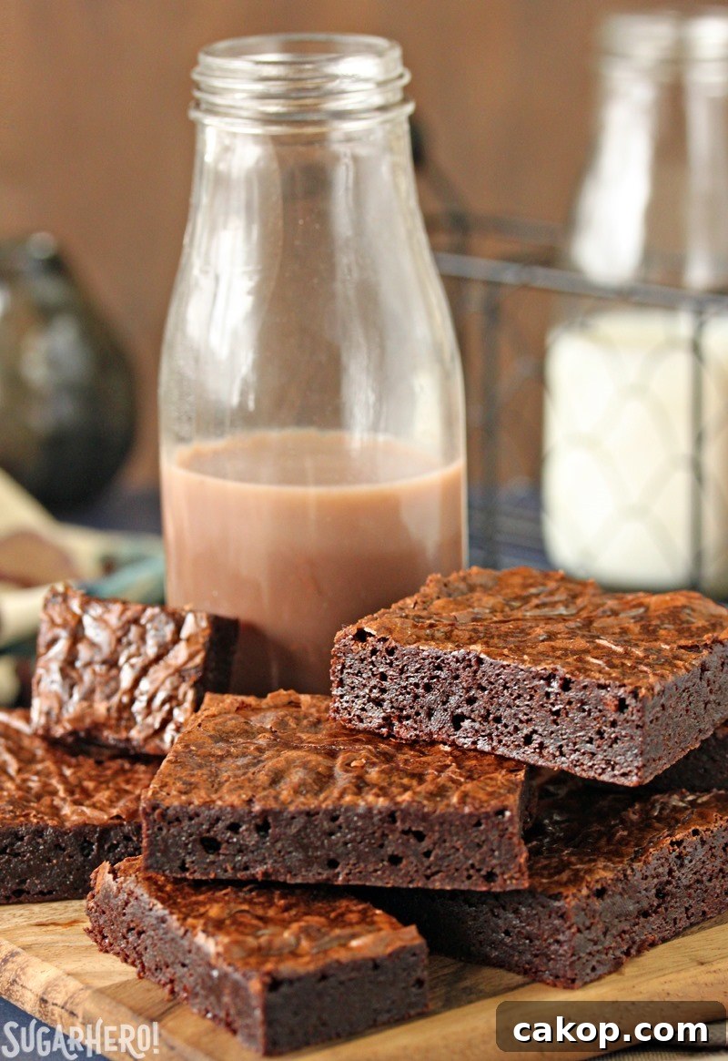 Ultimate Fudgy Chocolate Brownies - moist, fudgy brownies with a crackly top Ultimate Fudgy Chocolate Brownies - brownies on a plate with chocolate milk
