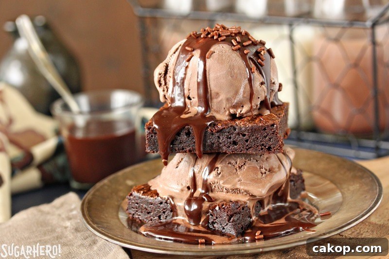 Brownies with ice cream and chocolate sauce Ultimate Fudgy Chocolate Brownies - brownies topped with ice cream and dripping chocolate sauce