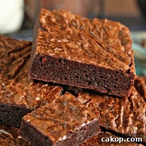 Fudgy Chocolate Brownies Recipe for Rich, Gooey Results 4 Close up of a pile of square cut Ultimate Fudgy Chocolate Brownies.