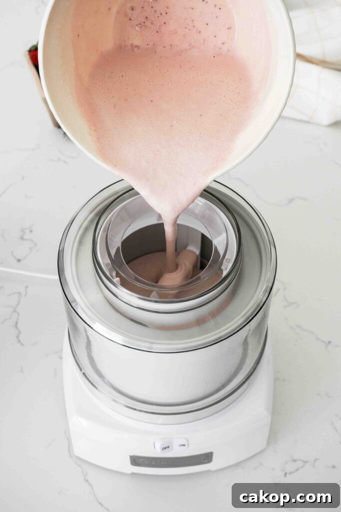 Homemade Strawberry Ice Cream Recipe with Fresh Berries 9 Strawberry custard is poured into an ice cream maker.