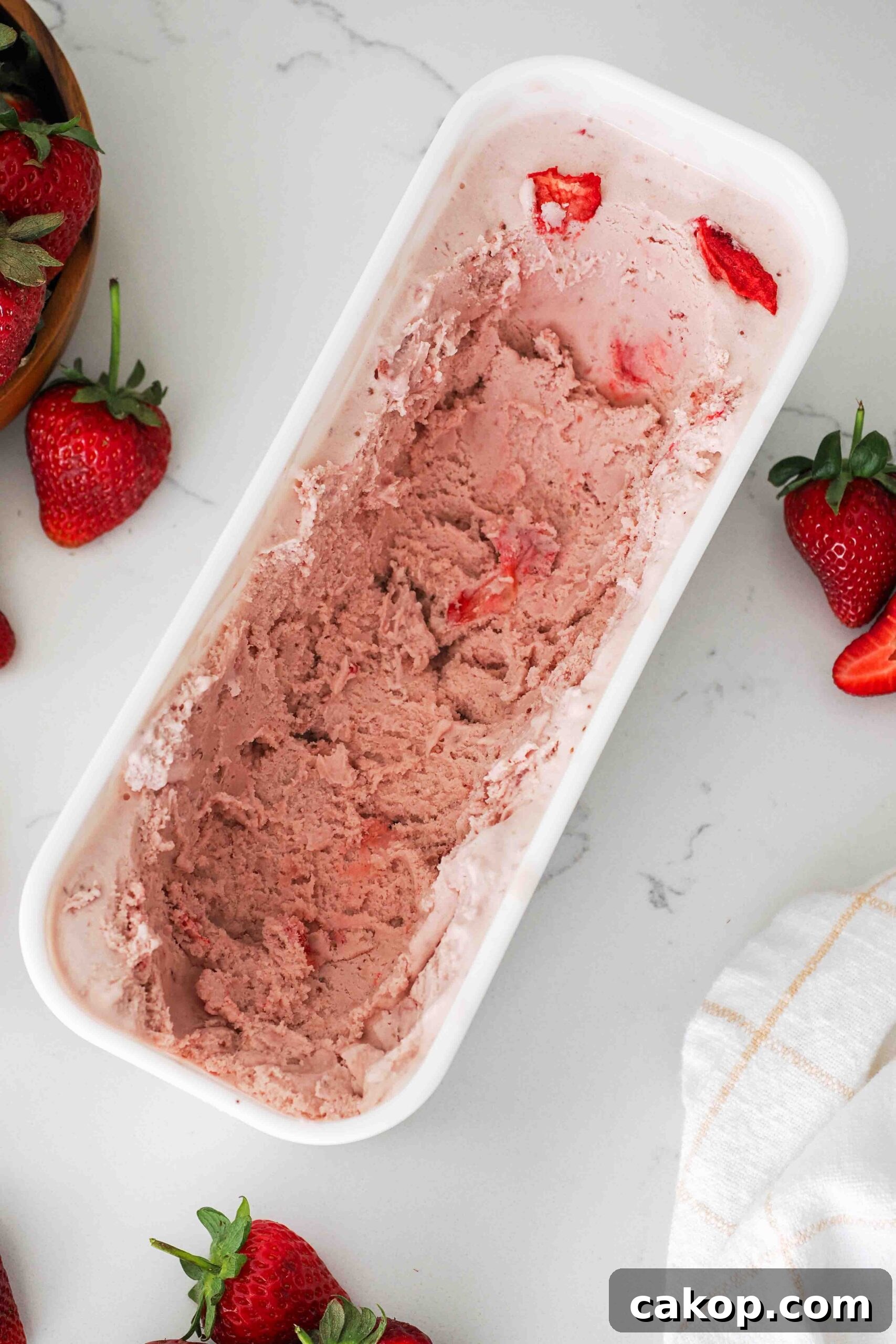 Homemade Strawberry Ice Cream Recipe with Fresh Berries 12 Leftover strawberry ice cream in a container.