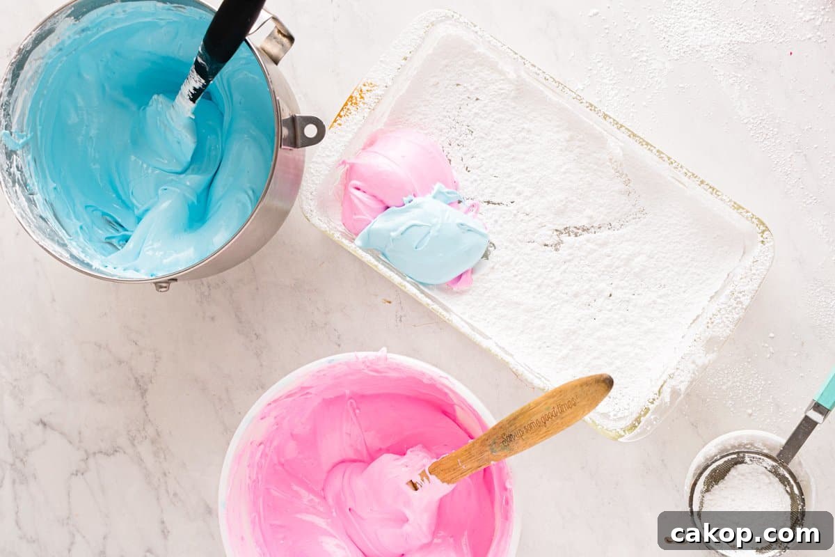 Cotton Candy Marshmallows: Fluffy Homemade Treats to Try 8 pink and blue marshmallow mixtures being added to a white rectangular pan.