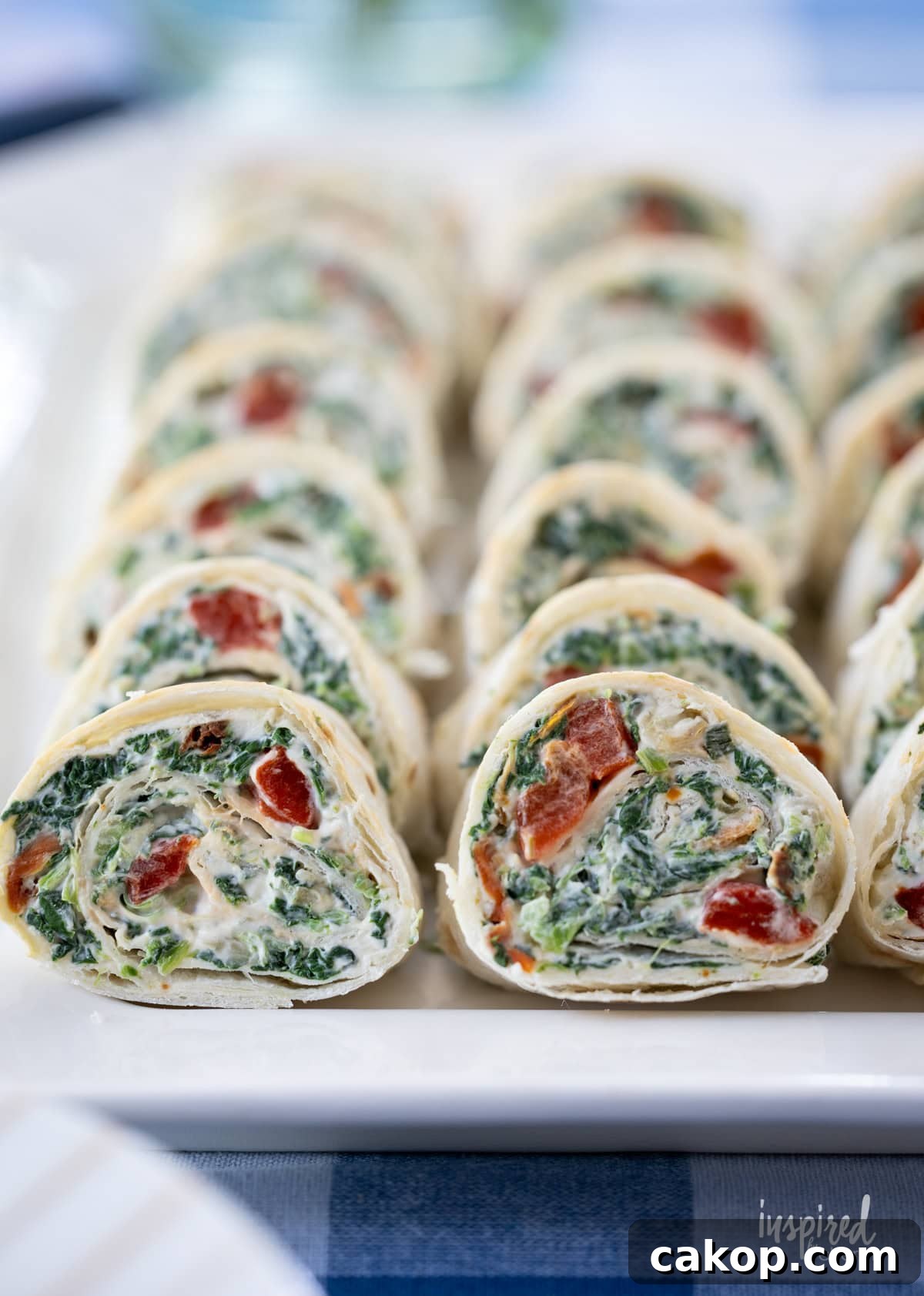 array of Spinach Dip Roll-Ups on a platter.