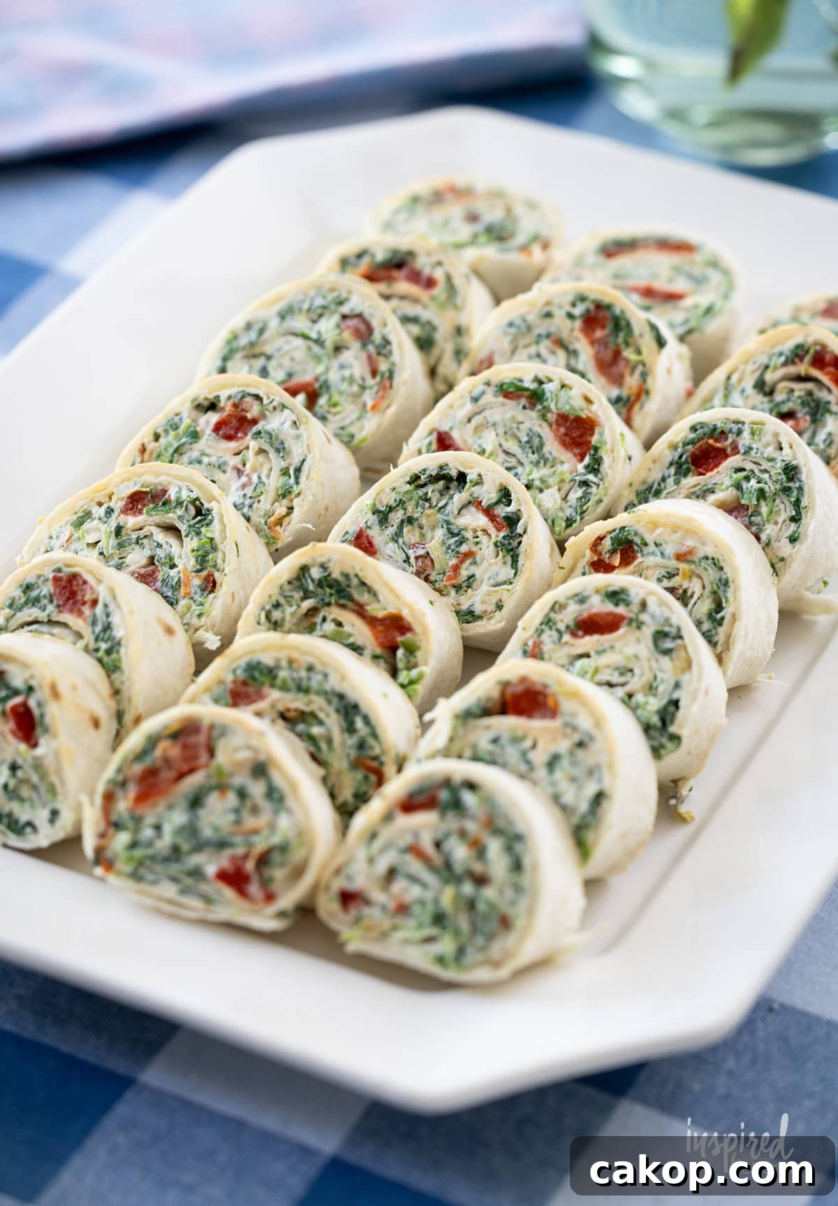 rows of Spinach Dip Roll-Ups on a plate.