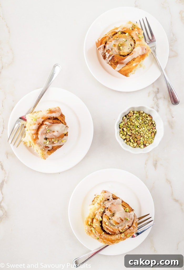 Pistachio Cinnamon Rolls Drizzled with Tahini Glaze 4 Three pistachio and tahini rolls.