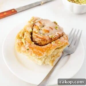 Tahini and pistachio cinnamon roll on small plate.