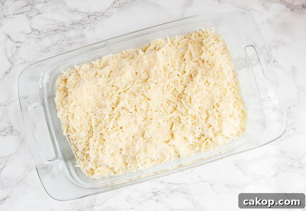 overhead view of keto alfredo casserole with two types of cheese layered on top