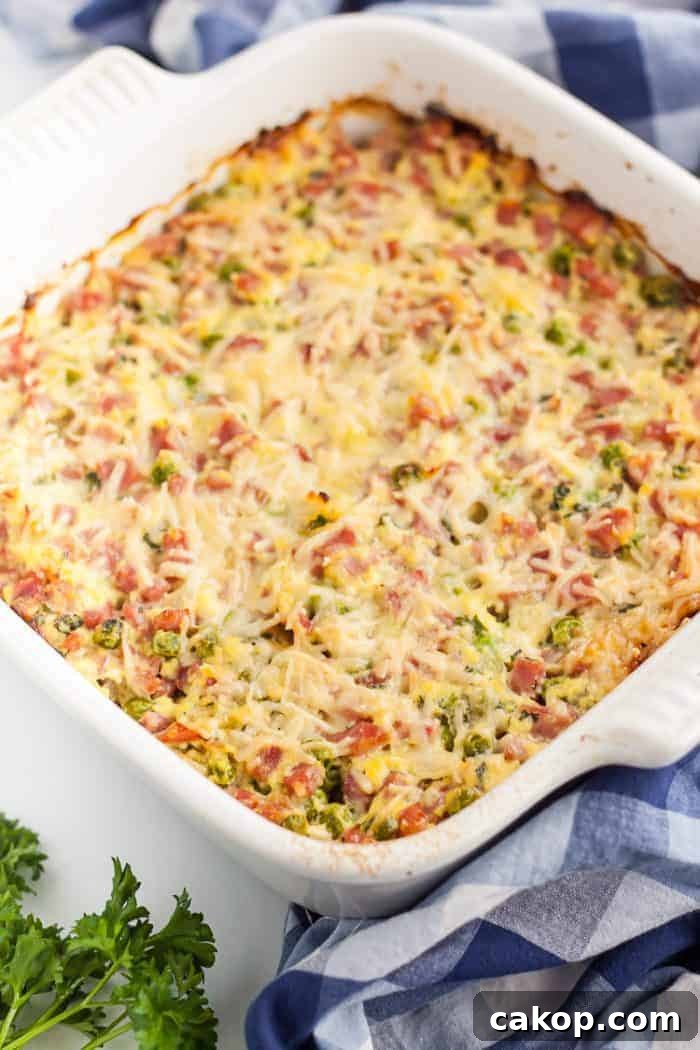 keto ham casserole in a white casserole dish next to a towel
