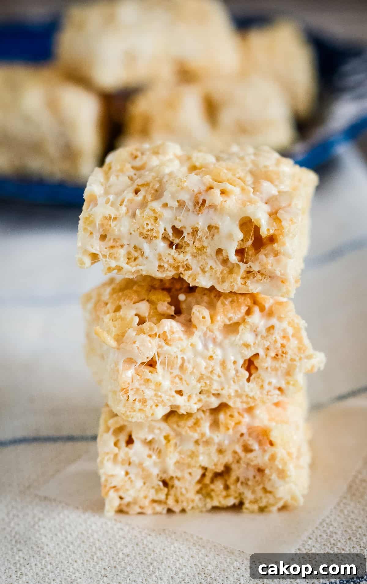 Brown Butter Rice Krispie Treats Recipe That Melt in Your Mouth 2 stack of brown butter rice krispie treats on waxed paper