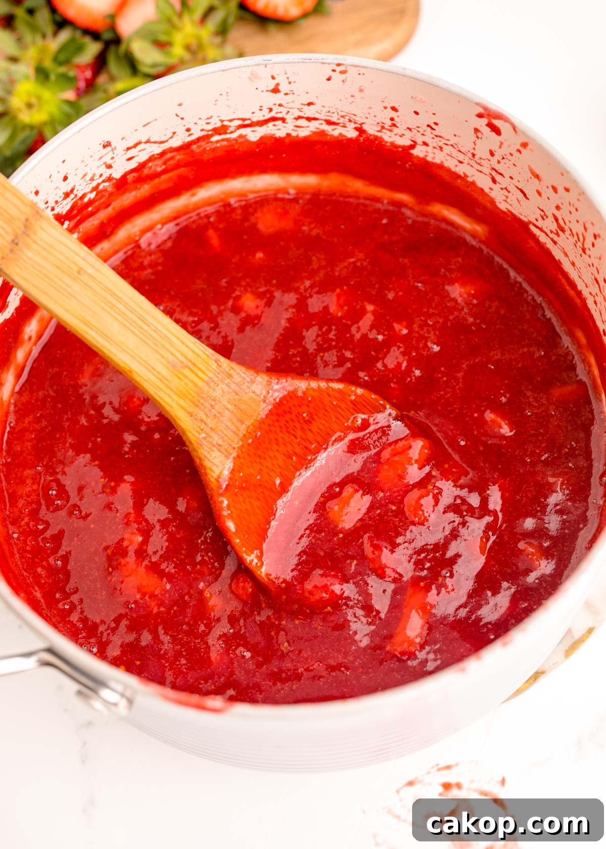 Strawberry Puree Recipe: Quick Homemade Strawberry Sauce 2 Close up photo of strawberry puree in a pot.