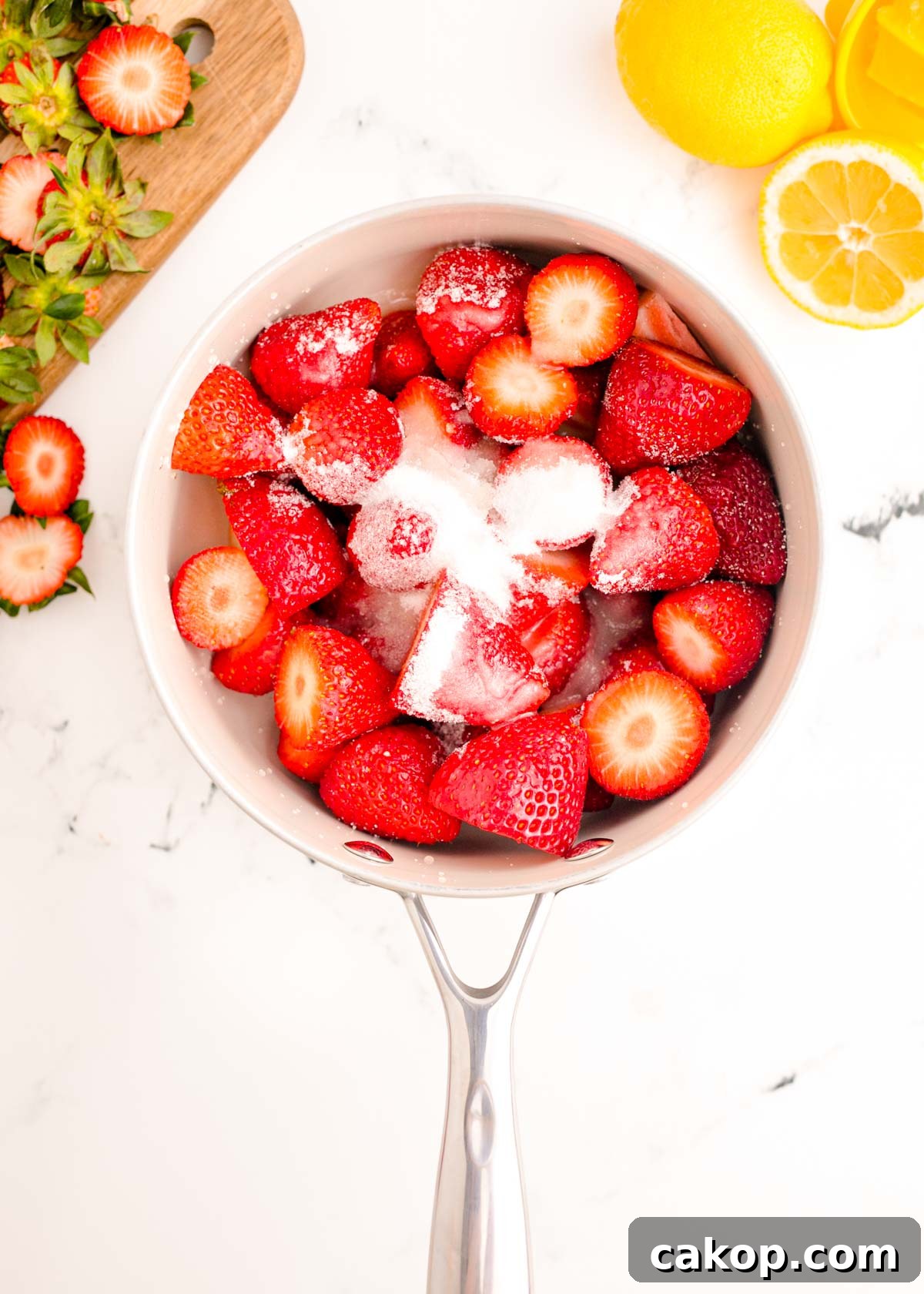 Strawberry Puree Recipe: Quick Homemade Strawberry Sauce 3 Strawberries, sugar, and lemon juice on a white marble counter.
