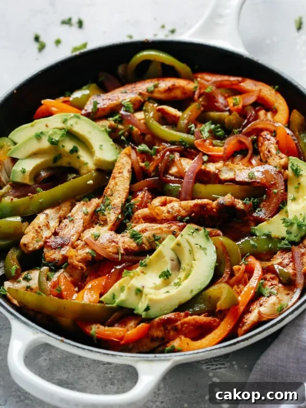 chicken fajitas topped with avocado slices