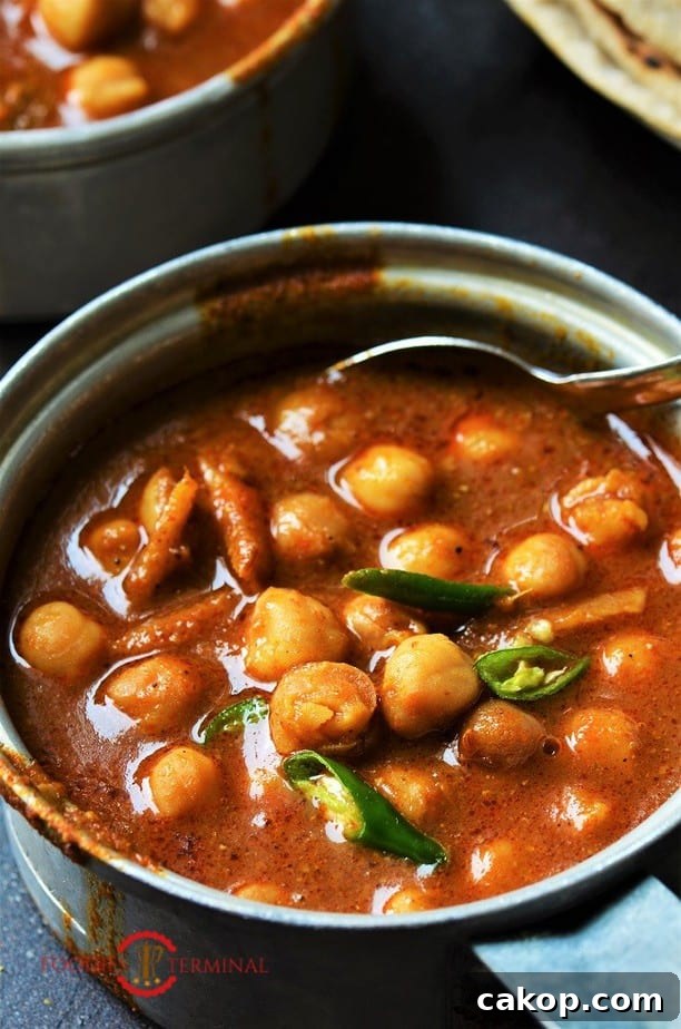 Instant Pot Punjabi Chole served in a pot garnished with chilies