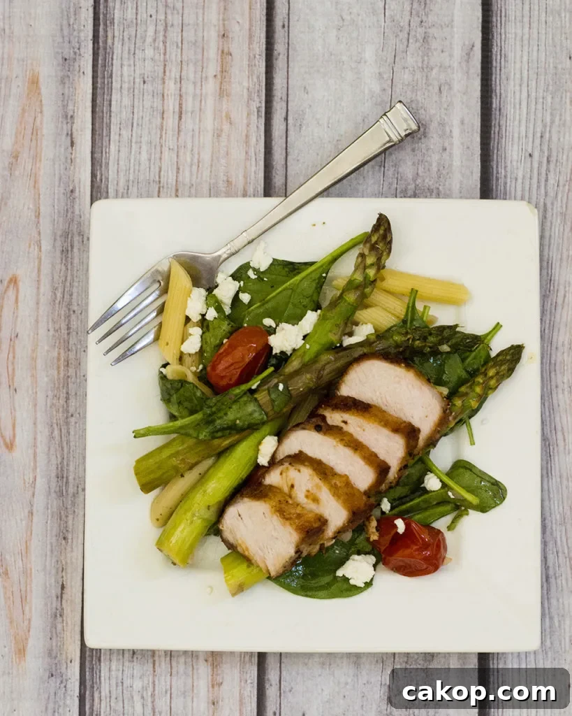 This versatile pasta salad combines roasted asparagus and tomatoes with penne and spinach, dressed in a low-calorie lemon vinaigrette. #CLBlogger TheRedheadBaker.com
