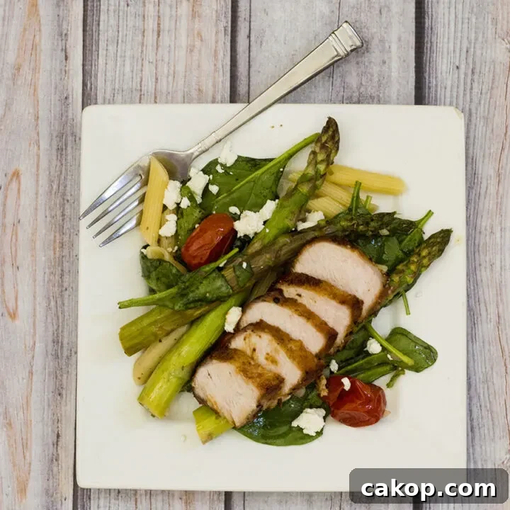 This versatile pasta salad combines roasted asparagus and tomatoes with penne and spinach, dressed in a low-calorie lemon vinaigrette. #CLBlogger TheRedheadBaker.com