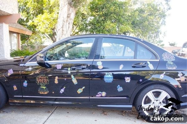 a black car with window cling Halloween parade decorations