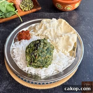 Healthy Keerai Pachai Payaru Masiyal served with rice and papad. Traditional South Indian vegetarian.