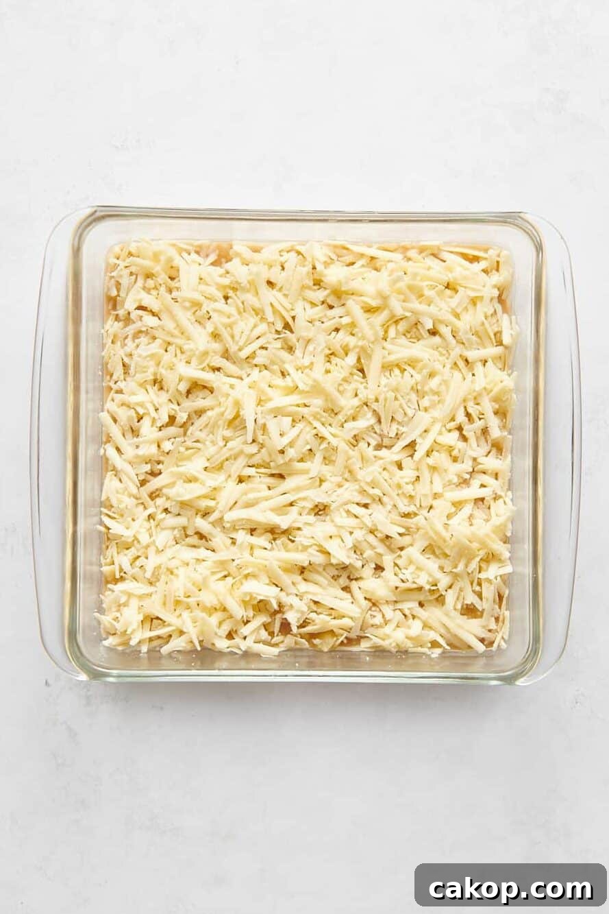 pineapple cheese casserole unbaked in a glass 8x8 casserole dish.