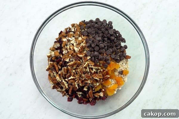 Oats, nuts, and dried fruit combined in a bowl