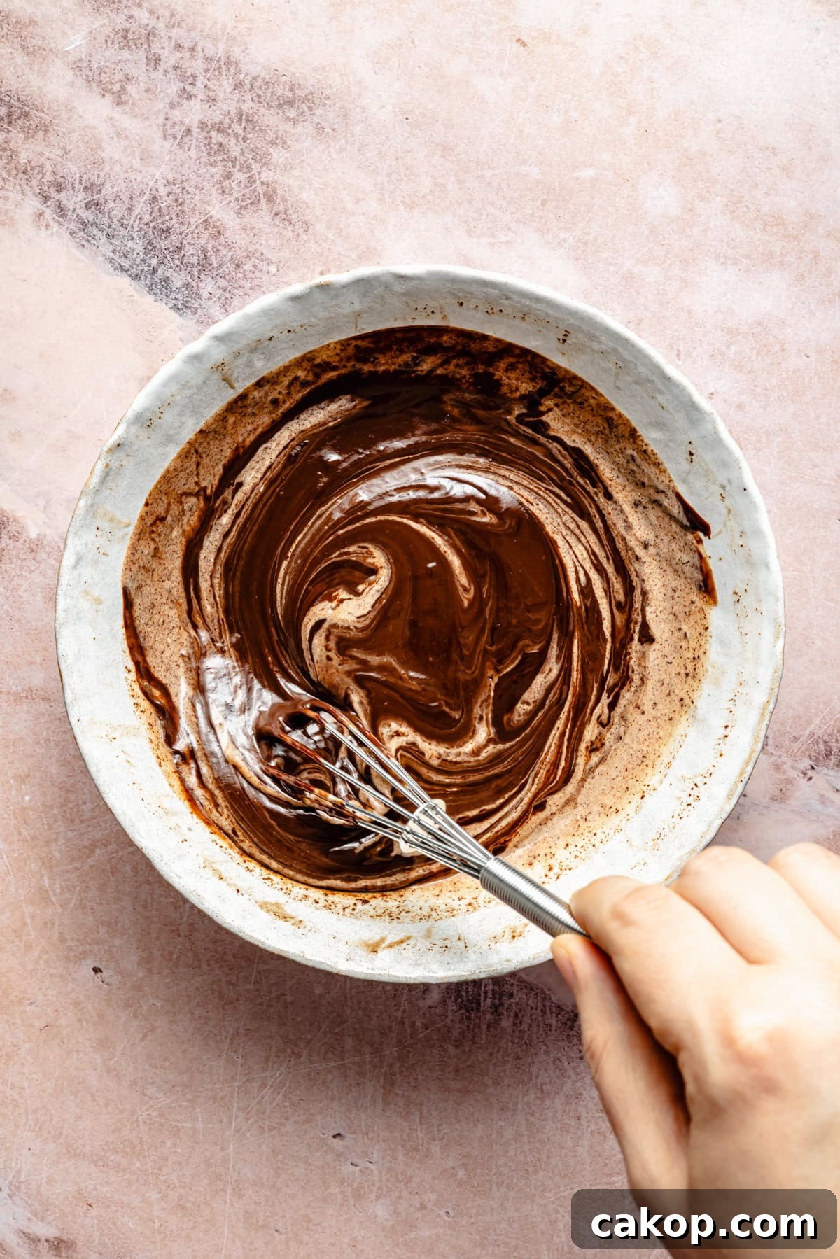 Chocolate Puppy Chow Cookies Recipe for Parties and Gifts 6 whisking chocolate ganache in a mixing bowl.