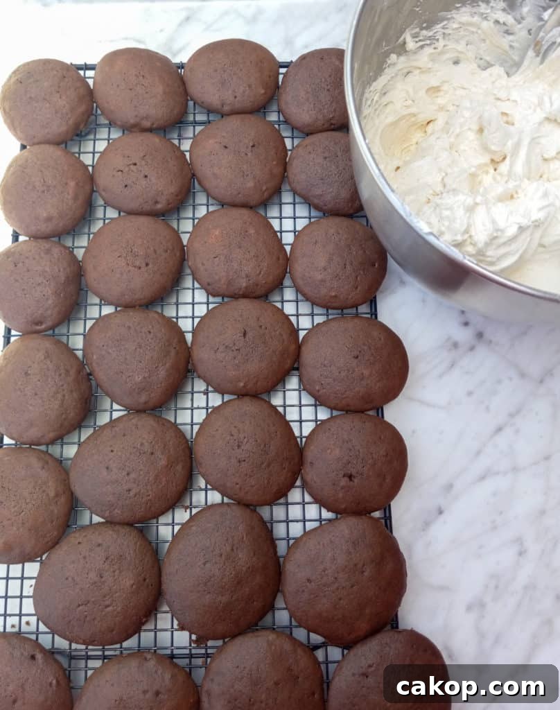 Amish Chocolate Whoopie Pies Recipe — Classic Soft Sandwich Cakes 4 chocolate cookies on a wire rack and filling in a bowl.