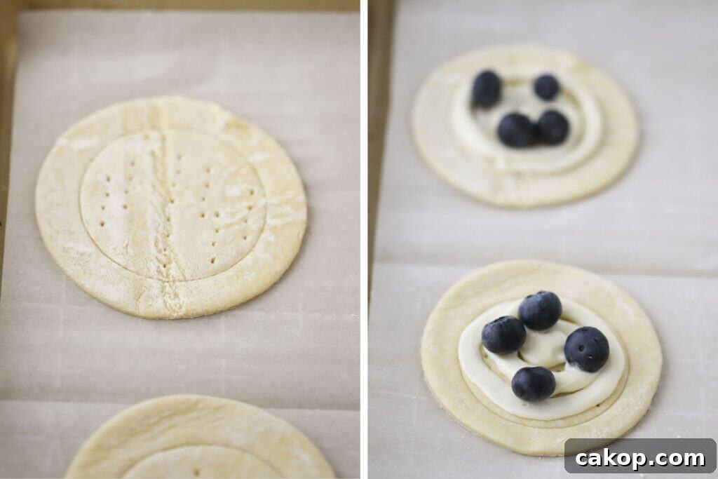 Puff pastry dough cut into circles with cream cheese filling and fresh blueberries over the top.