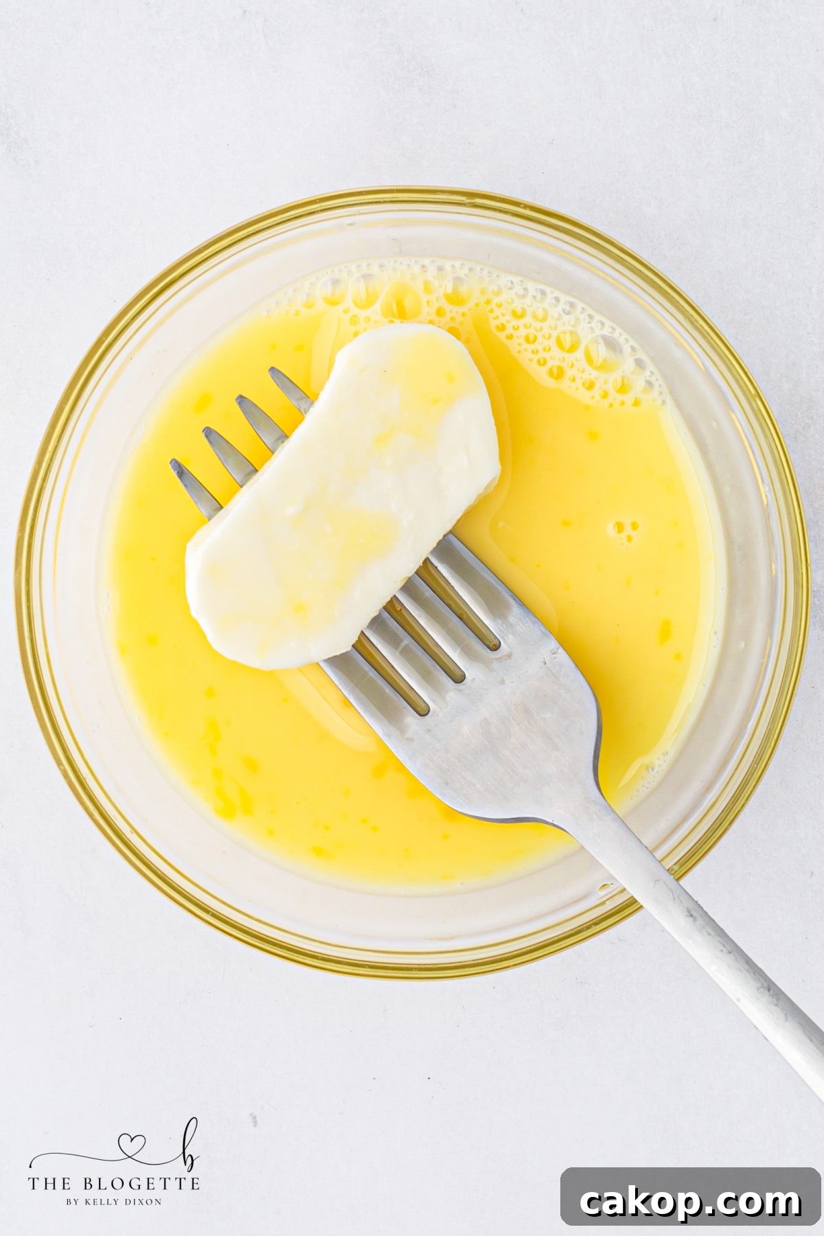 Dip the mozzarella slices in the egg
