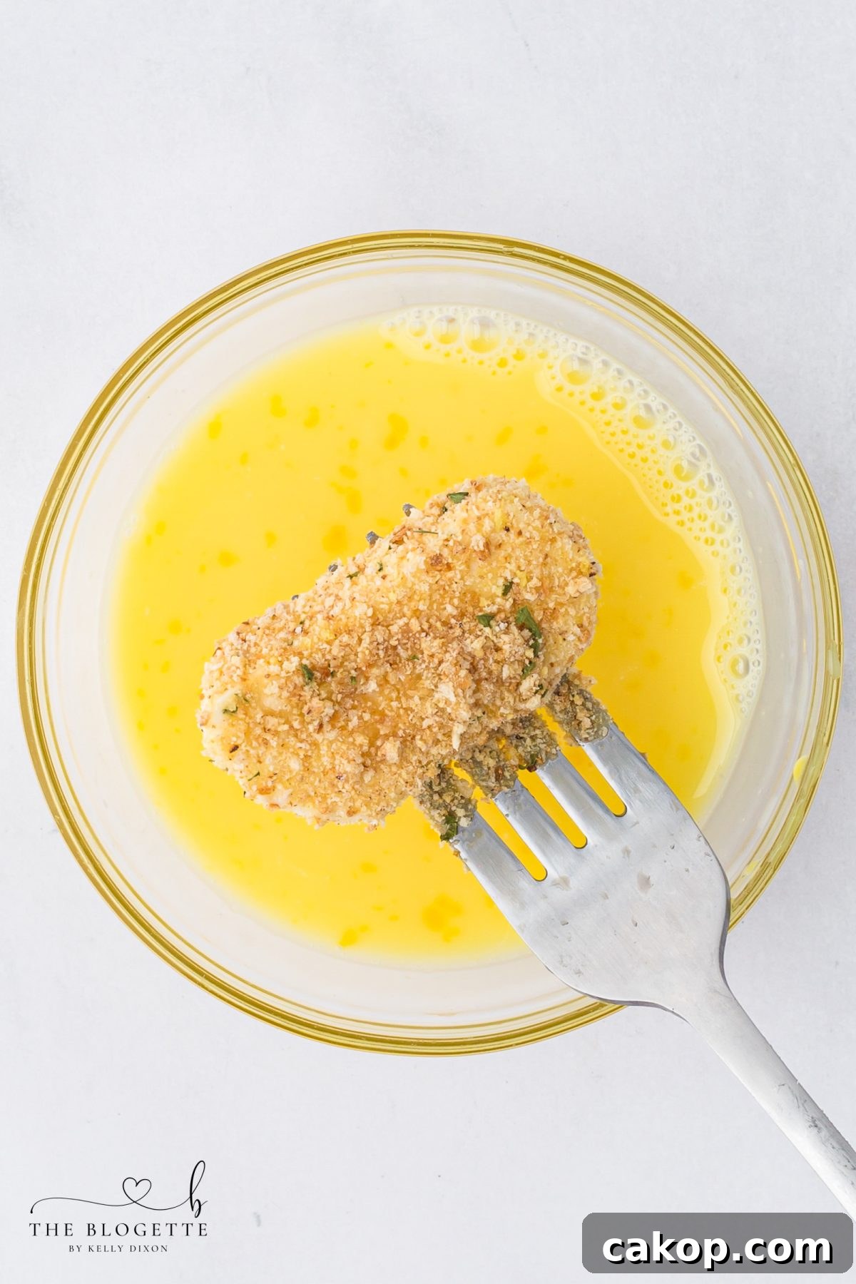 Dip the mozzarella slices in the egg
