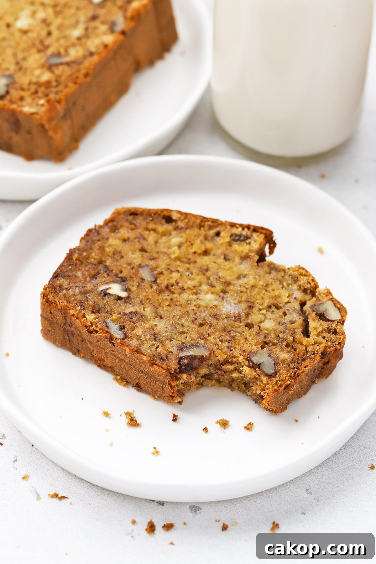 Brown Butter Banana Bread (Gluten-Free Recipe) 8 Front view of a slice of gluten free brown butter banana bread with a bite taken out of it