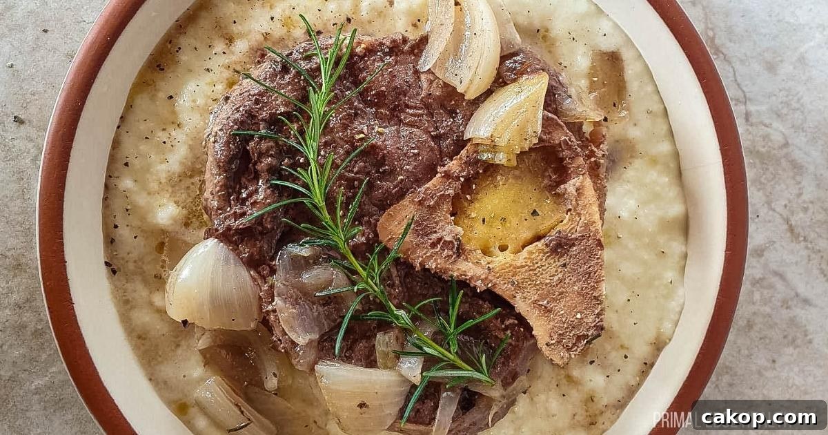 A picture of an easy beef shank slow cooker recipe over cauliflower mash with rosemary.