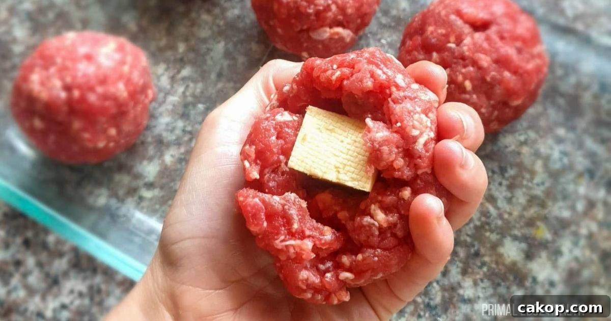 Meatballs with cheese on a plate.