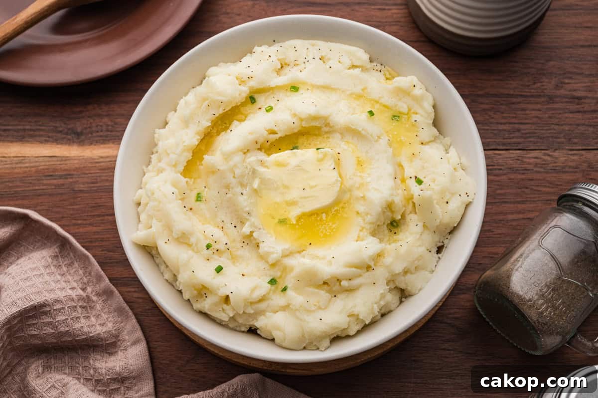 Classic Old-Fashioned Mashed Potatoes Recipe for Creamy Comfort 9 Bowl of old fashioned mashed potatoes topped with a pat of butter.