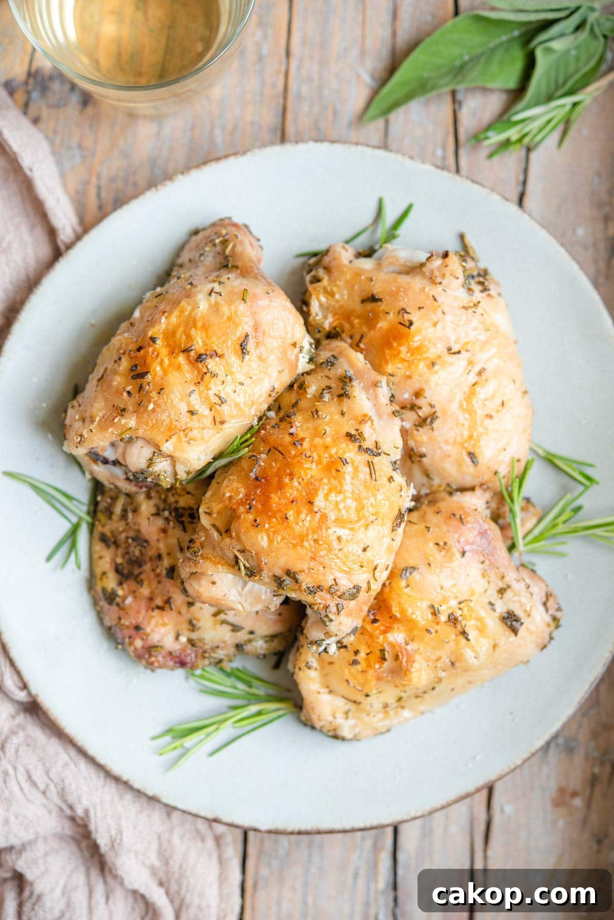 Crispy Italian-Style Baked Chicken Thighs 2 An overhead shot of Italian baked chicken thighs on a plate with rosemary